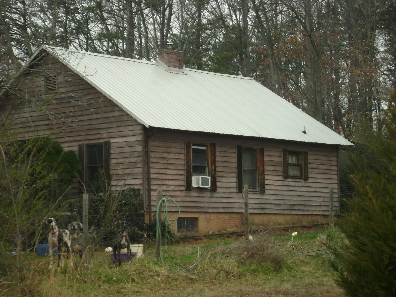 White metal roof on an old wood sided farmhouse, from a Metal Roof Installation job in Acworth